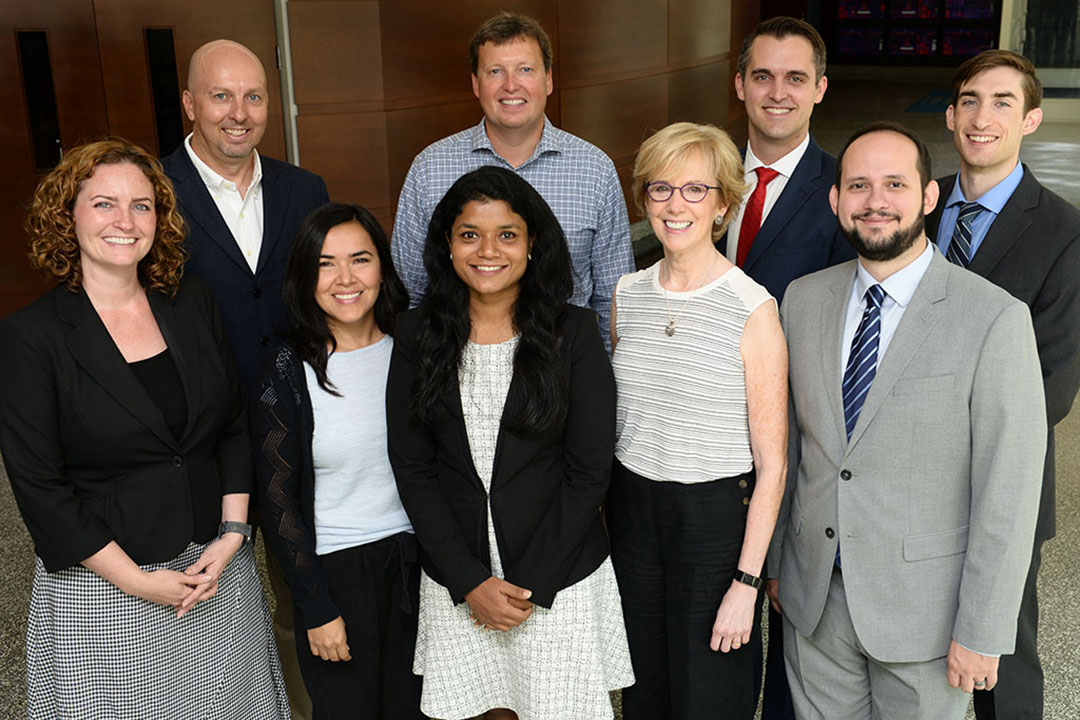 A group of staff from the Regulatory Studies Center standing together and smiling