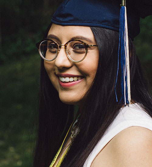 Vanessa Lopez in a graduation cap and glasses